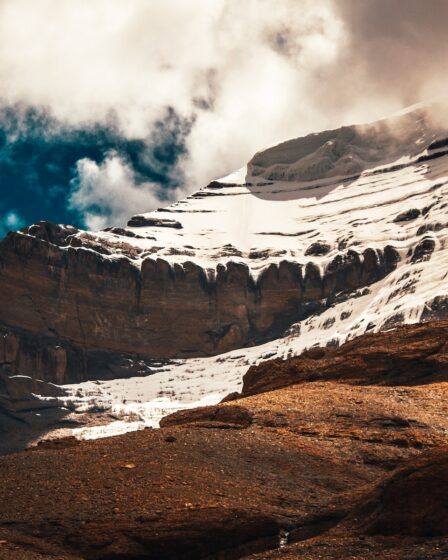 rocky mountain under cloudy sky during daytime